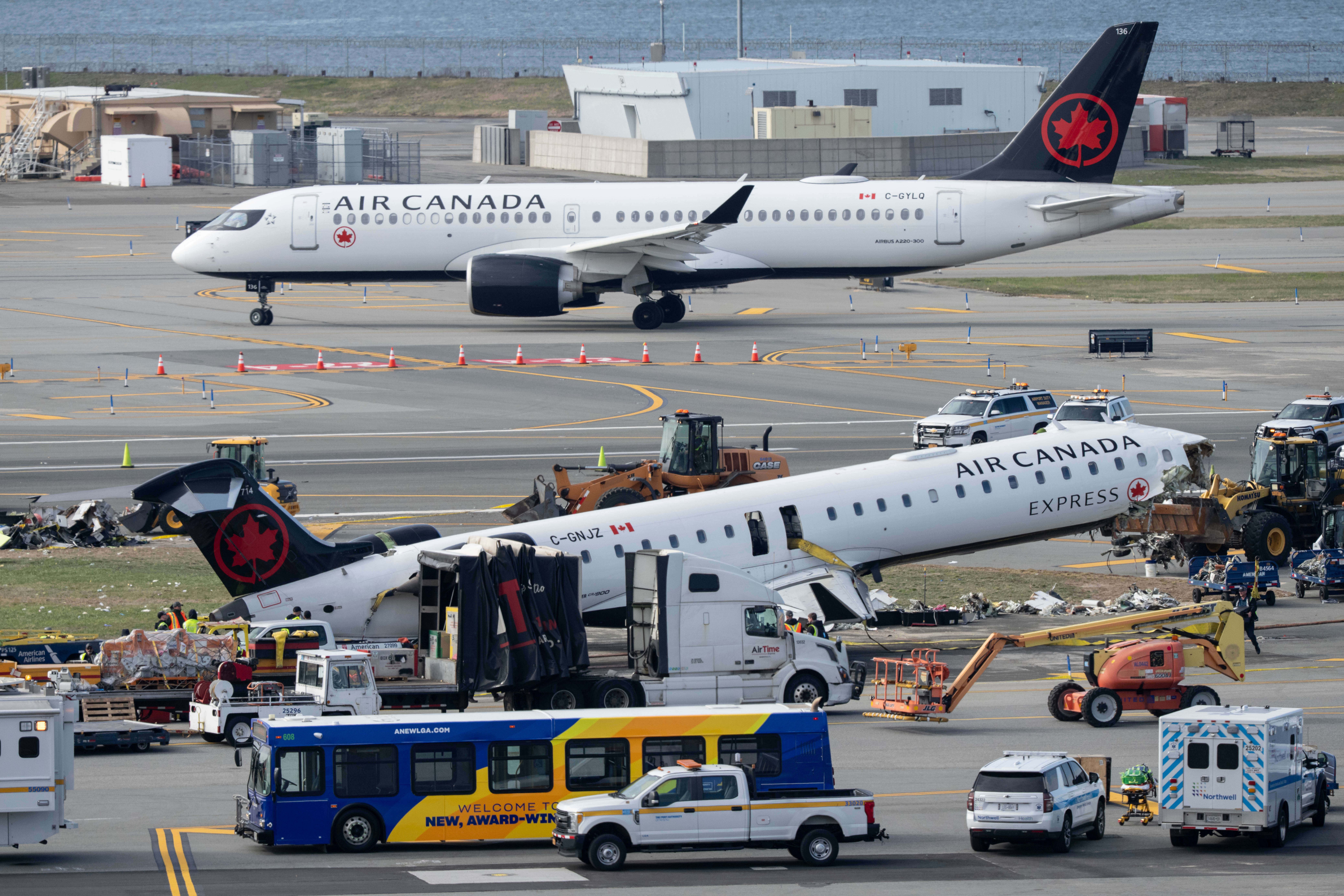 Mangled plane in LaGuardia crash is towed from runway as most injured passengers leave hospital